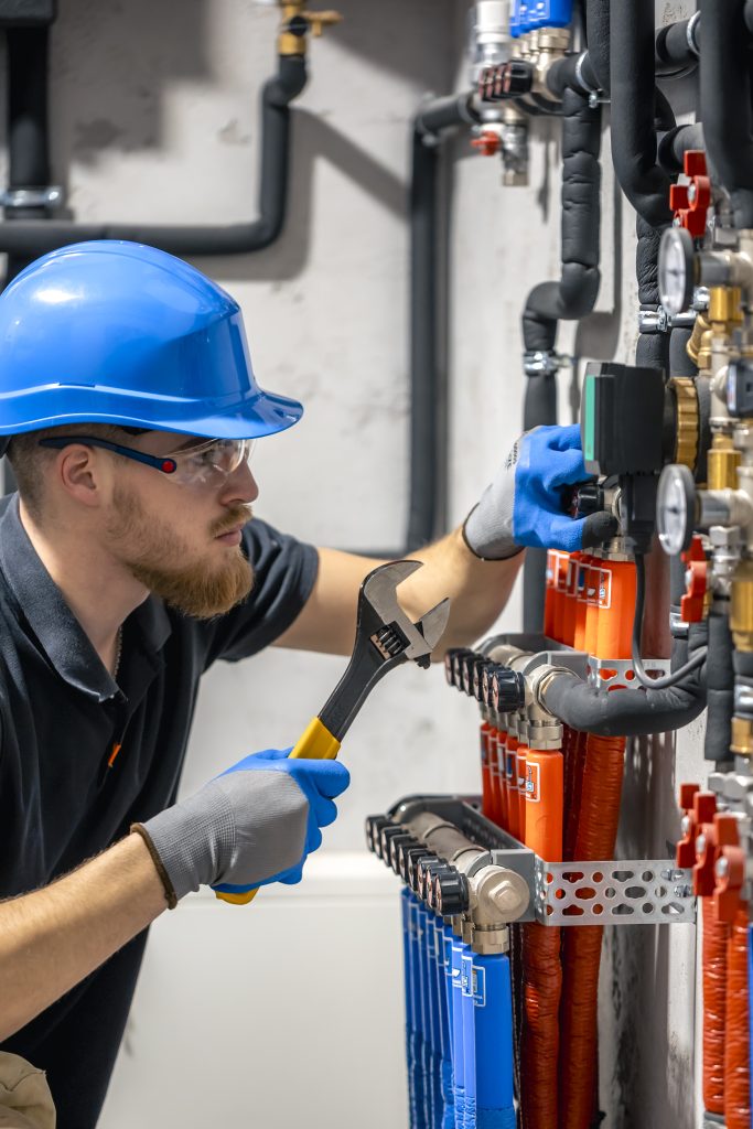 technician checking heating system boiler room